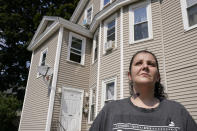 Roxanne Schaefer, of West Warwick, R.I., stands for a photograph outside of her apartment building, in West Warwick, Tuesday, July 27, 2021. Schaefer, who is months behind on rent, is bracing for the end to a CDC federal moratorium Saturday, July 31, 2021, a move that could result in millions of people being evicted just as the highly contagious delta variant of the coronavirus is rapidly spreading. (AP Photo/Steven Senne)