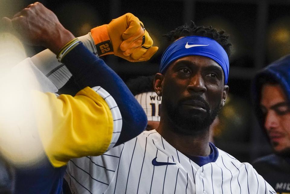 Milwaukee Brewers' Andrew McCutchen is congratulated after hitting a home run during the first inning of a baseball game against the Washington Nationals Saturday, May 21, 2022, in Milwaukee. (AP Photo/Morry Gash)