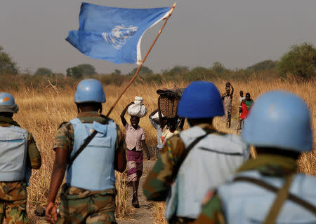 United Nations Mission in South Sudan (UNMISS) peacekeepers meet women and children on their path during a patrol near Bentiu, northern South Sudan, February 11, 2017. REUTERS/Siegfried Modola