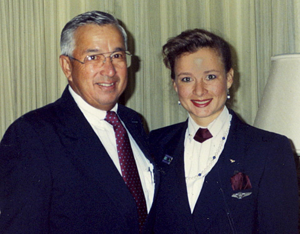 In this 1991 family photo, Ron Akana poses in his flight attendant uniform with his daughter Jean Akana-Lewis. Akana, 83, worked his last route over the weekend on a United Airlines flight from Denver to Kauai, ending his career in the state where it began. Hawaii, however, wasn't his final stop. His destination is retirement in Boulder, Colo., where he has been living since 2002 to be closer to his grandchildren. He spent his first few days of retirement writing thank-you notes to well-wishers. Guinness World Records sent Akana a plaque recognizing him as the longest-serving flight attendant. He's been told he'll appear in the record book in October. (AP Photo/Courtesy of Jean Akana-Lewis)