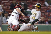 Oakland Athletics' Sean Murphy (12) slides out at home as he is tagged out by Boston Red Sox's Christian Vazquez, left, in the seventh inning of a baseball game, Thursday, May 13, 2021, in Boston. (AP Photo/Steven Senne)