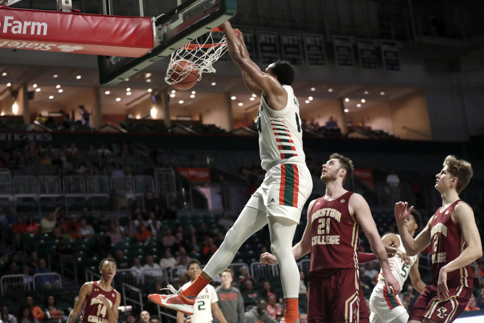 Miami center Rodney Miller Jr., left dunks over Boston College forward Nik Popovic (21) and guard Julian Rishwain (2) during the second half of an NCAA college basketball game, Wednesday, Feb. 12, 2020, in Coral Gables, Fla. Miami won 85-58. (AP Photo/Lynne Sladky)