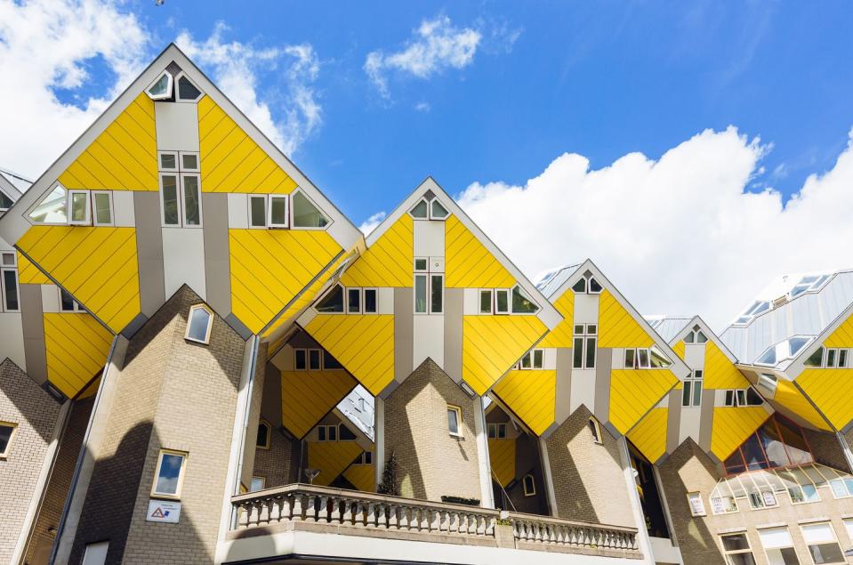 <p>As if the geometric architecture wasn’t enough, a lemon-yellow facade creates a striking home exterior.</p>