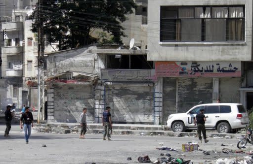 Image released by the Syrian opposition Shaam News Network shows UN monitors in Homs' Khalidiyah neighbourhood, May 22. Syrian forces tried to storm the rebel bastion of Rastan, reports said. AFP is using pictures from alternative sources as it was not authorised to cover this event and is not responsible for any alterations which cannot be independently verified