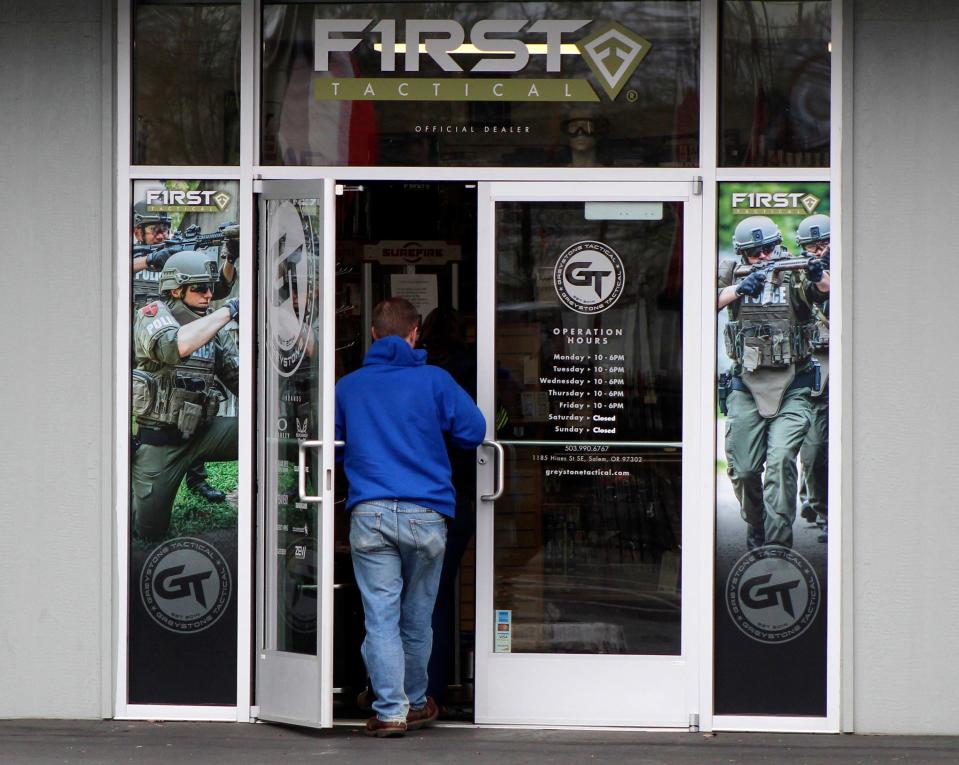 A man enters a gun shop in Salem, Oregon, on Feb. 19, 2021. Voters in Oregon passed one of the nation's strictest gun control laws, which bans magazines over 10 rounds.