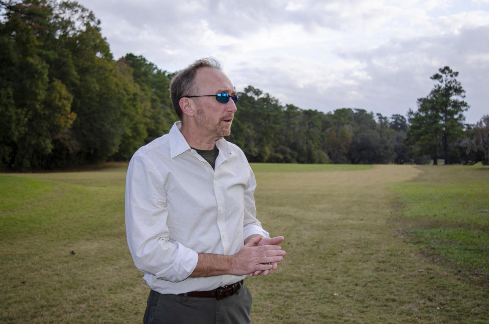 Jeffrey Shanks, an archaeologist with the National Park Service, visits an unmarked slave cemetery on Dec. 16, 2019, at the Capital City Country Club in Tallahassee, Fla. Shanks earlier this year brought in ground-penetrating radar and two cadaver-sniffing dogs to investigate if long-told stories about a cemetery at the golf course are true. His search indicates that there are at least 40 graves near the 7th hole tee. (AP Photo/Bobby Caina Calvan)