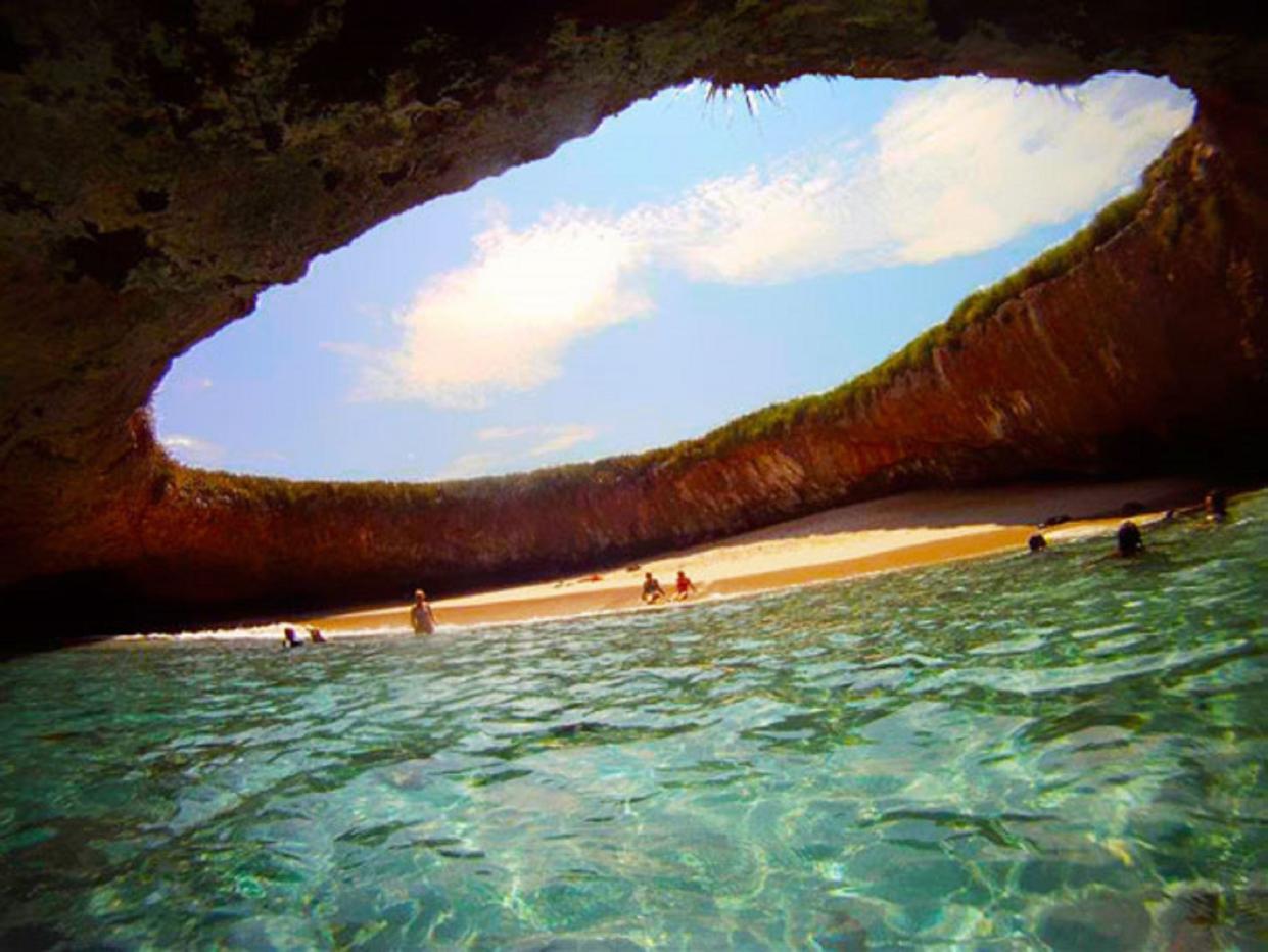 Playa Del Amor, with its open dome hole, is known as Hidden Beach and is located on the uninhabited Marieta Islands off the coast of Punta Mita in the Riviera Nayarit.