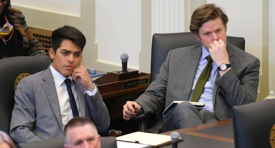 Rep. Arturo Alonso-Sandoval, left, and Rep. Forrest Bennett listen to Gov. Kevin Stitt's State of the State address as the 2023 legislative session gets under way.