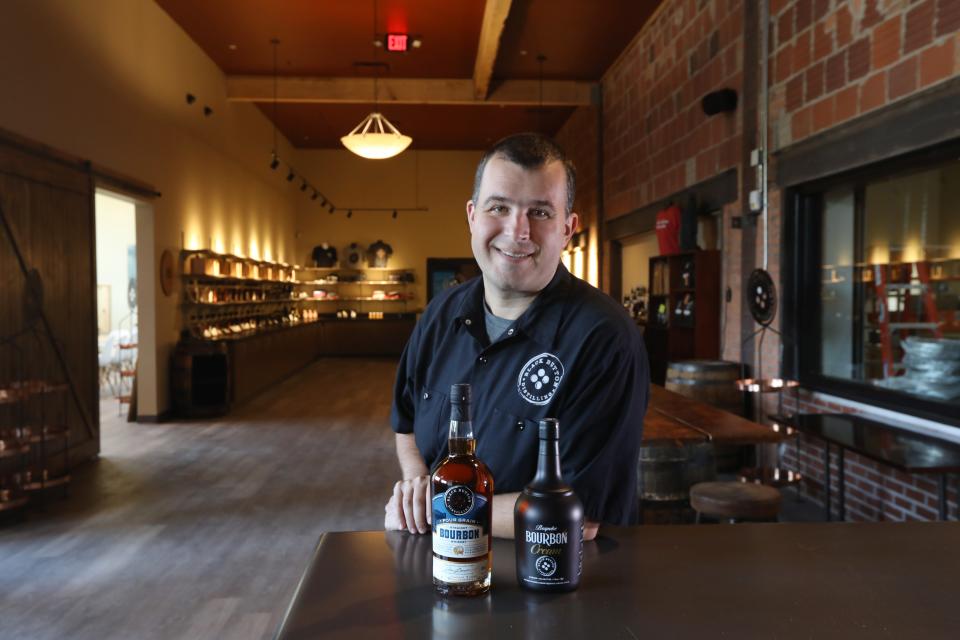 Owner Jason Barrett at the tasting bar inside the new location of Black Button Distilling, now located at 1344 University Ave in Rochester.