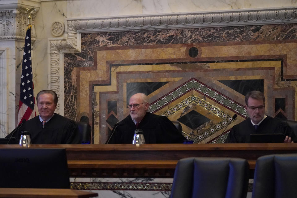 Judges Milan D. Smith Jr., from left, sits on a panel with Sidney R. Thomas and Michael J. McShane before hearing arguments at the Ninth Circuit Court of Appeals in San Francisco, Monday, Nov. 14, 2022. Apple is heading into a courtroom faceoff against Epic Games, the company behind the popular Fortnite video game, reviving a high-stakes antitrust battle over whether the digital fortress shielding the iPhone's app store illegally enriches the world's most valuable company while stifling competition. (AP Photo/Jeff Chiu)