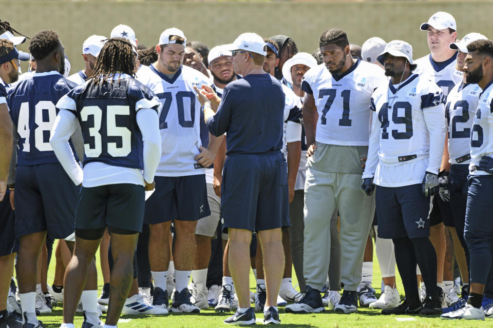 Dallas Cowboys head coach Jason Garrett, center, talks with his players during practice at the NFL football team's training camp in Oxnard, Calif., Saturday, July 27, 2019. (AP Photo/Michael Owen Baker)