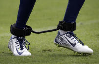 Tennessee Titans defensive back Tommie Campbell runs a drill with a training device on his ankles during NFL football training camp Sunday, July 27, 2014, in Nashville, Tenn. (AP Photo/Mark Humphrey)