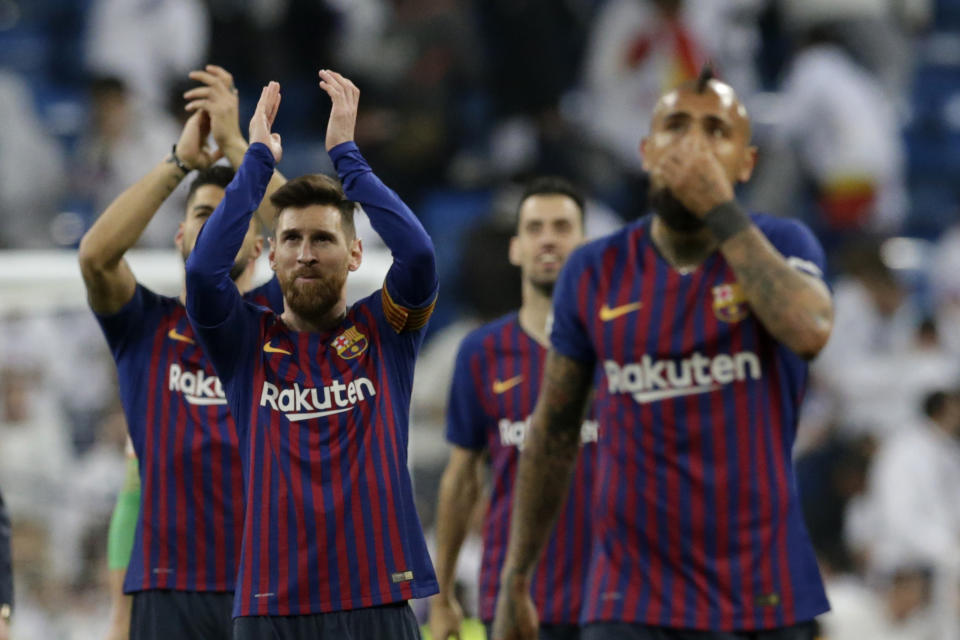 Barcelona forward Lionel Messi, left, applauds fans at the end of the Copa del Rey semifinal second leg soccer match between Real Madrid and FC Barcelona at the Bernabeu stadium in Madrid, Spain, Wednesday Feb. 27, 2019. (AP Photo/Andrea Comas)