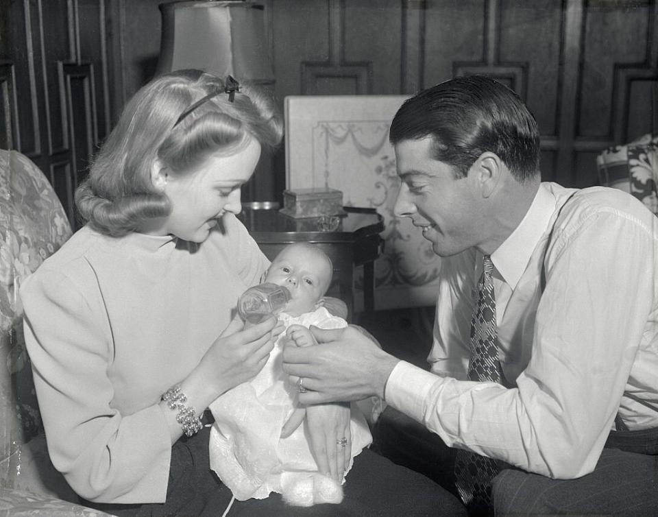 <p>The baseball star, who played for the New York Yankees his entire career, is pictured here with his first wife, Dorothy, and their son, Joe DiMaggio Jr., in their New York apartment. He later married Marilyn Monroe.</p>