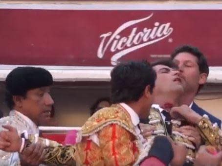 Arturo Macias is carried from the ring after being gored in the neck: Facebook/screengrab