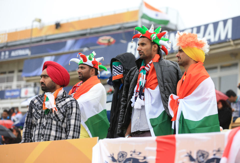 Indian fans shelter from the rain during the ICC Champions Trophy Final at Edgbaston, Birmingham.