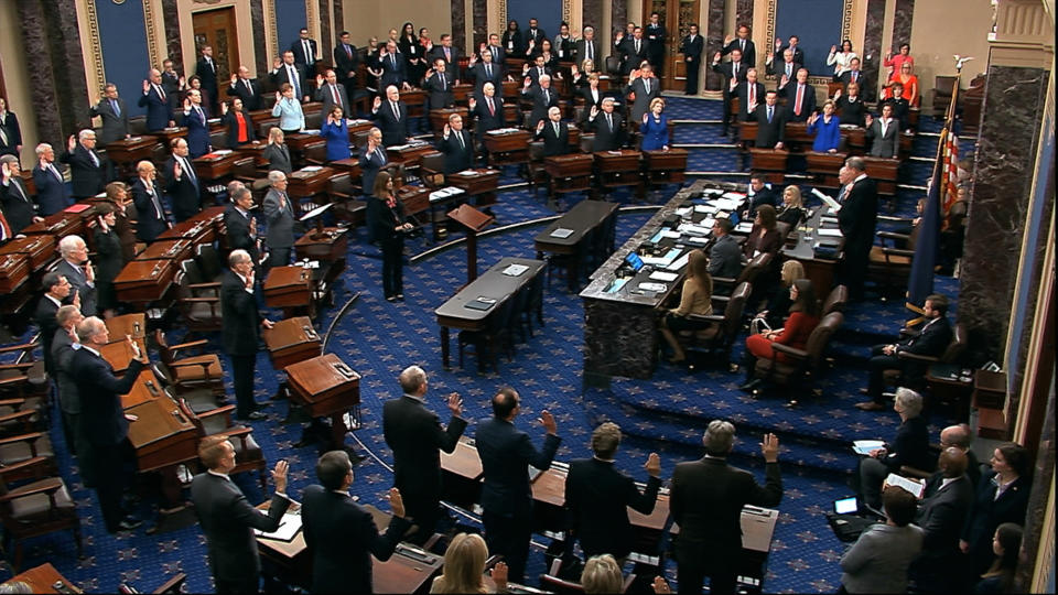 FILE - In this Thursday, Jan. 16, 2020, file image from video, presiding officer Supreme Court Chief Justice John Roberts swears in members of the Senate for the impeachment trial against President Donald Trump at the U.S. Capitol in Washington. Reporters at the Capitol want more cameras in the Senate to cover the impeachment trial and fewer restrictions to talk to senators when they are not sitting in judgment of the president. (Senate Television via AP, File)