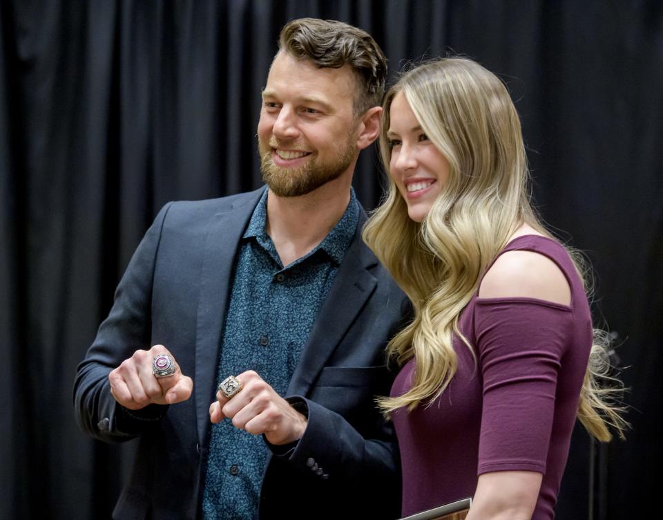 Former Chicago Cubs and Kansas City Royals star Ben Zobrist, left, shows his World Series rings as he poses with former IVC volleyball player Kenna Wollard, now at Purdue, during the induction ceremony for the 2023 Greater Peoria Sports Hall of Fame on Saturday, March 25, 2023 at the Peoria Civic Center. Wollard was chosen as the Female Athlete of the Year.