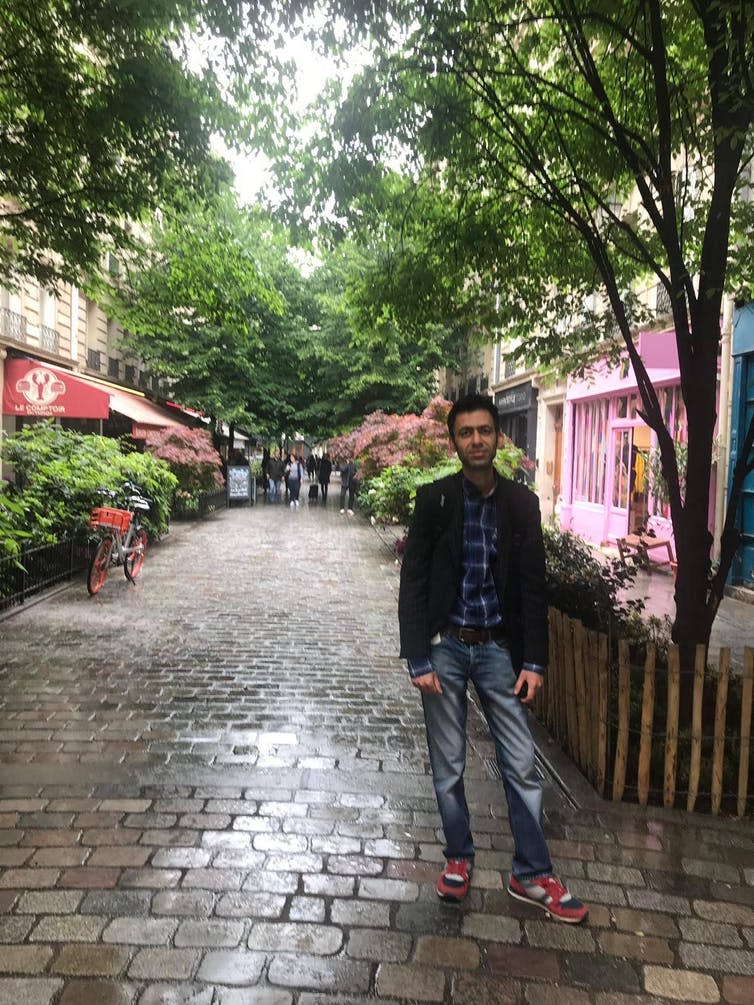 Man standing on a Paris street.