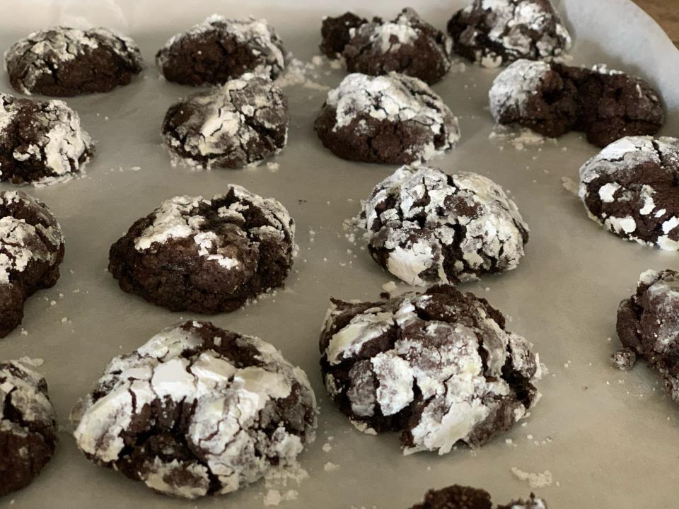 trader joes chocolate peppermint loaf mix turned into cooked crinkle cookies on parchment-lined baking sheet