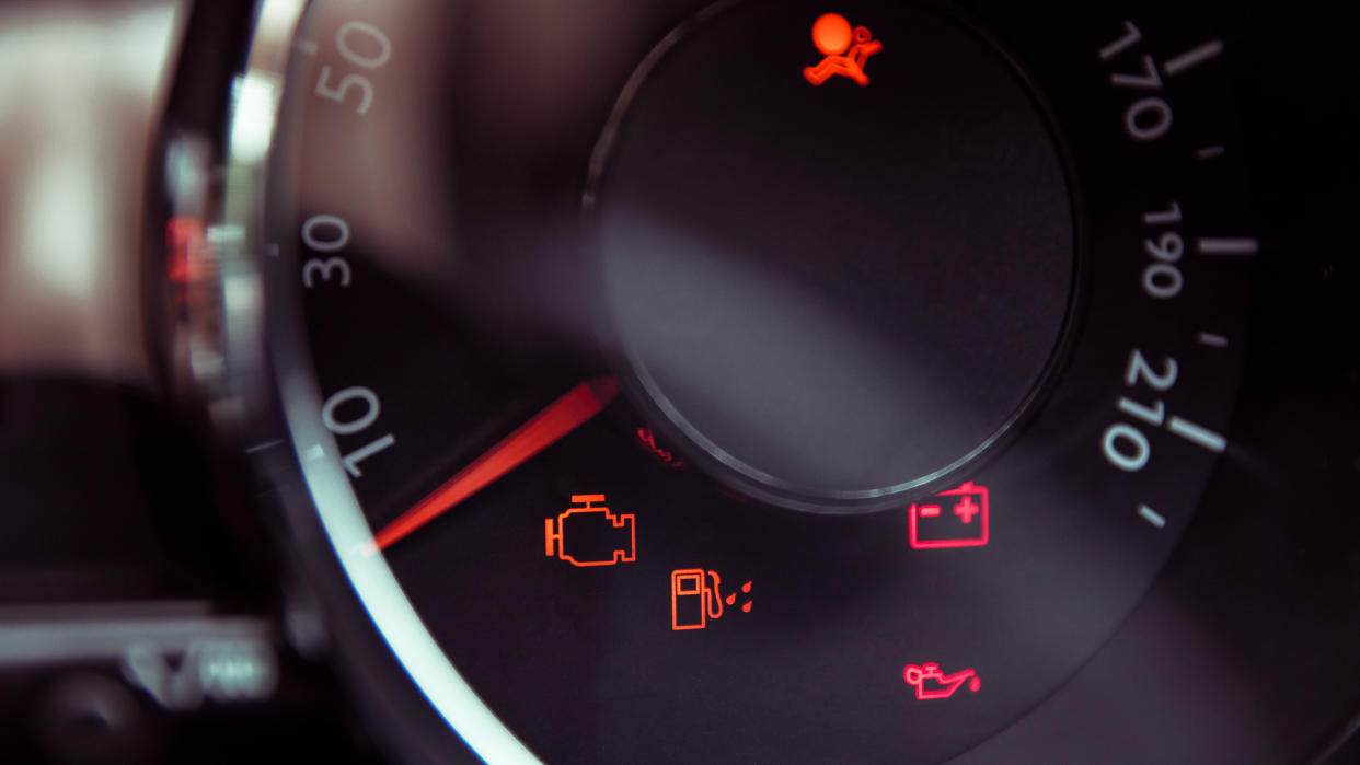 Many different car dashboard lights in closeup.