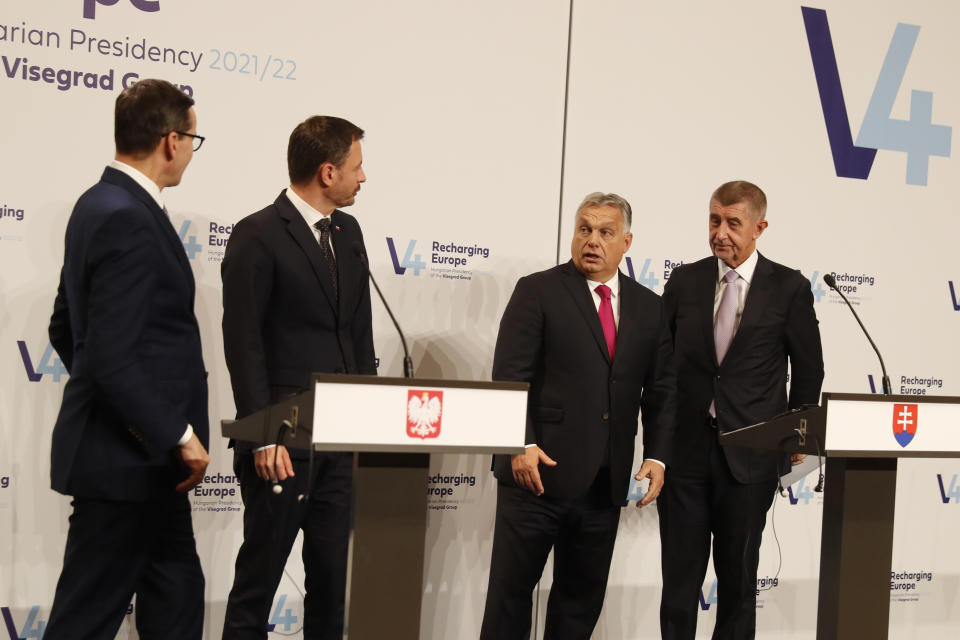 From left: Prime Ministers Mateusz Morawiecki of Poland, , Eduard Heger of Slovakia, Viktor Orban of Hungary and Andrej Babis of the Czech Republic look at each other after a news briefing in Budapest, Hungary, Tuesday, Nov. 23, 2021. The leaders of the Visegrad Four group of Central European countries met in Hungary's capital of Budapest Tuesday to discuss the ongoing migration crisis along Poland's border with Belarus. (AP Photo/Laszlo Balogh)