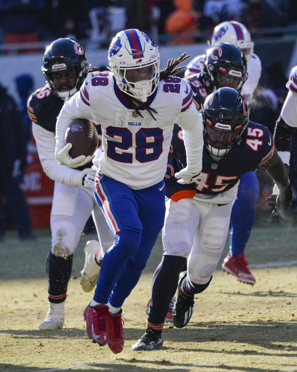 Buffalo Bills running back James Cook (28) get past Chicago Bears linebacker Joe Thomas (45) on his way to a touchdown in the second half of an NFL football game in Chicago, Saturday, Dec. 24, 2022. (AP Photo/Charles Rex Arbogast)