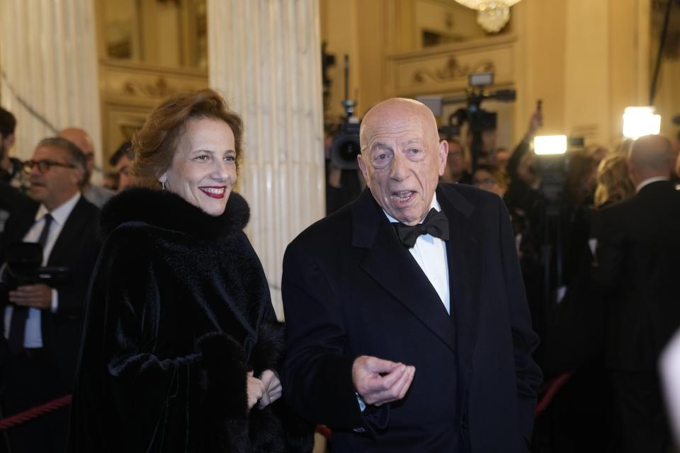 Fedele Confalonieri president of Mediaset and his wife Annick Cornet arrive to attend La Scala opera house's gala season opener, Giuseppe Verdi's opera 'Don Carlo' at the Milan La Scala theater, Italy, Thursday Dec. 7, 2023. The season-opener Thursday, held each year on the Milan feast day St. Ambrose, is considered one of the highlights of the European cultural calendar. (AP Photo/Luca Bruno)
