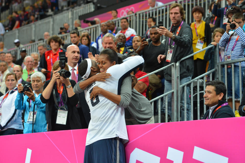 LeBron James #6 of the USA Mens Senior National team hugs The First Lady Michelle Obama after defeating France 98-71 at the Olympic Park Basketball Arena during the London Olympic Games on July 29, 2012 in London, England. NOTE TO USER: User expressly acknowledges and agrees that, by downloading and/or using this Photograph, user is consenting to the terms and conditions of the Getty Images License Agreement. Mandatory Copyright Notice: Copyright 2012 NBAE (Photo by Jesse D. Garrabrant/NBAE via Getty Images)
