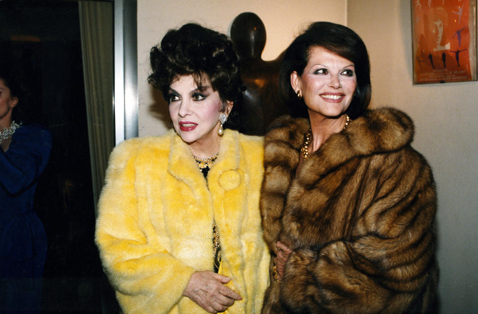 FILE - A photo taken in the 90s in Paris of Italian actress Gina Lollobrigida with Claudia Cardinale. Lollobrigida, who embodied the Italian stereotype of Mediterranean beauty and was dubbed “the most beautiful woman in the world” after the title of one her movies, has died in Rome at age 95. Italian news agency Lapresse reported Lollobrigida’s death on Monday, Jan. 16, 2023 quoting Tuscany Gov. Eugenio Giani. (Girella/LaPresse via AP)