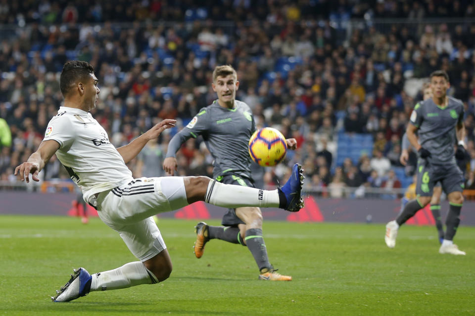 Real Madrid's Casemiro, left crosses the ball during a Spanish La Liga soccer match between Real Madrid and Real Sociedad at the Santiago Bernabeu stadium in Madrid, Spain, Sunday, Jan. 6, 2019. (AP Photo/Paul White)