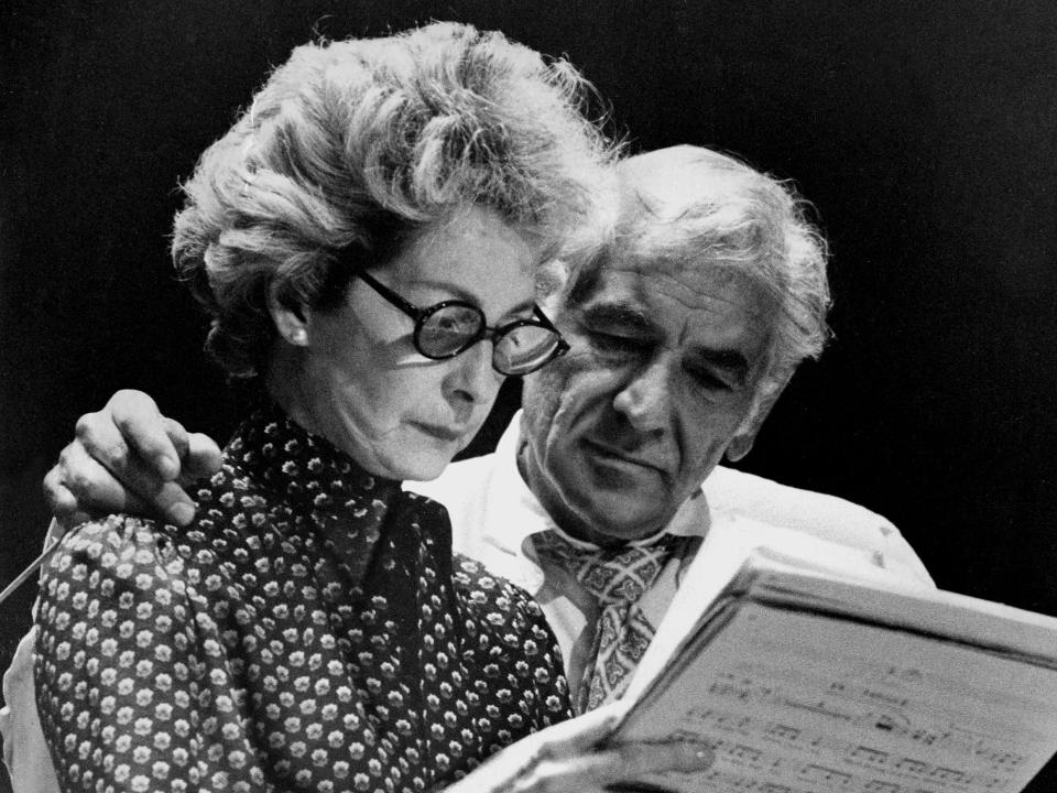 Felicia Montealegre studies sheet music while her husband Leonard Bernstein looks on in this 1977 black and white photograph.