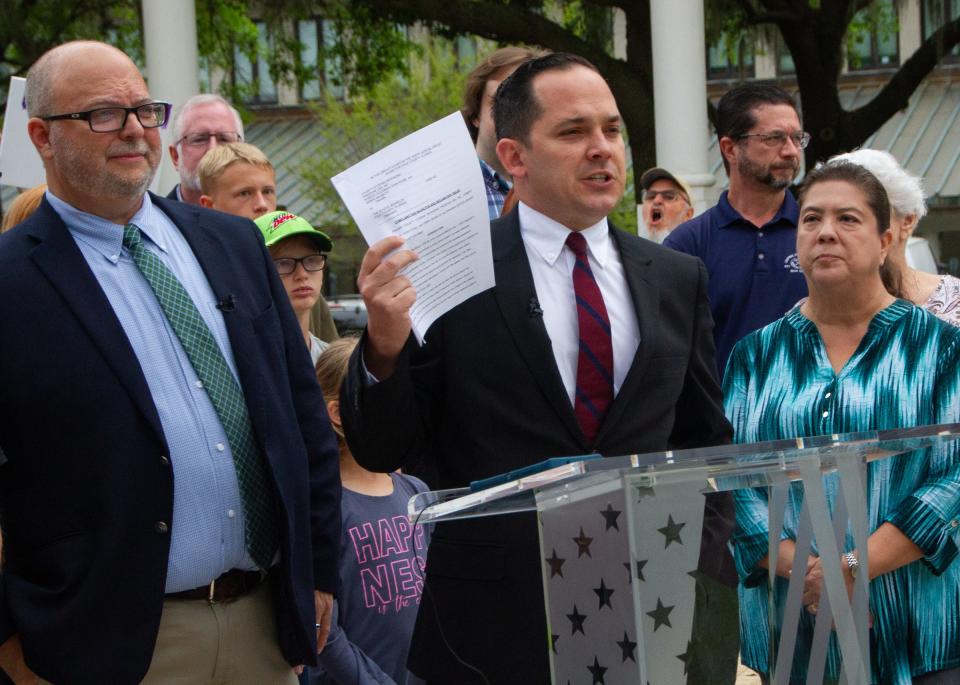 Anthony Sabatini, a lawyer representing Citizens Defending Freedom, holds a copy of the complaint he filed accusing the Polk County School Board of violating state law in its procedures for handling challenges to books in schools in March.