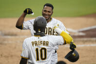 San Diego Padres' Edward Olivares, above, reacts with teammate Jurickson Profar (10) after hitting a home run during the fifth inning of a baseball game against the Arizona Diamondbacks, Friday, Aug. 7, 2020, in San Diego. (AP Photo/Gregory Bull)