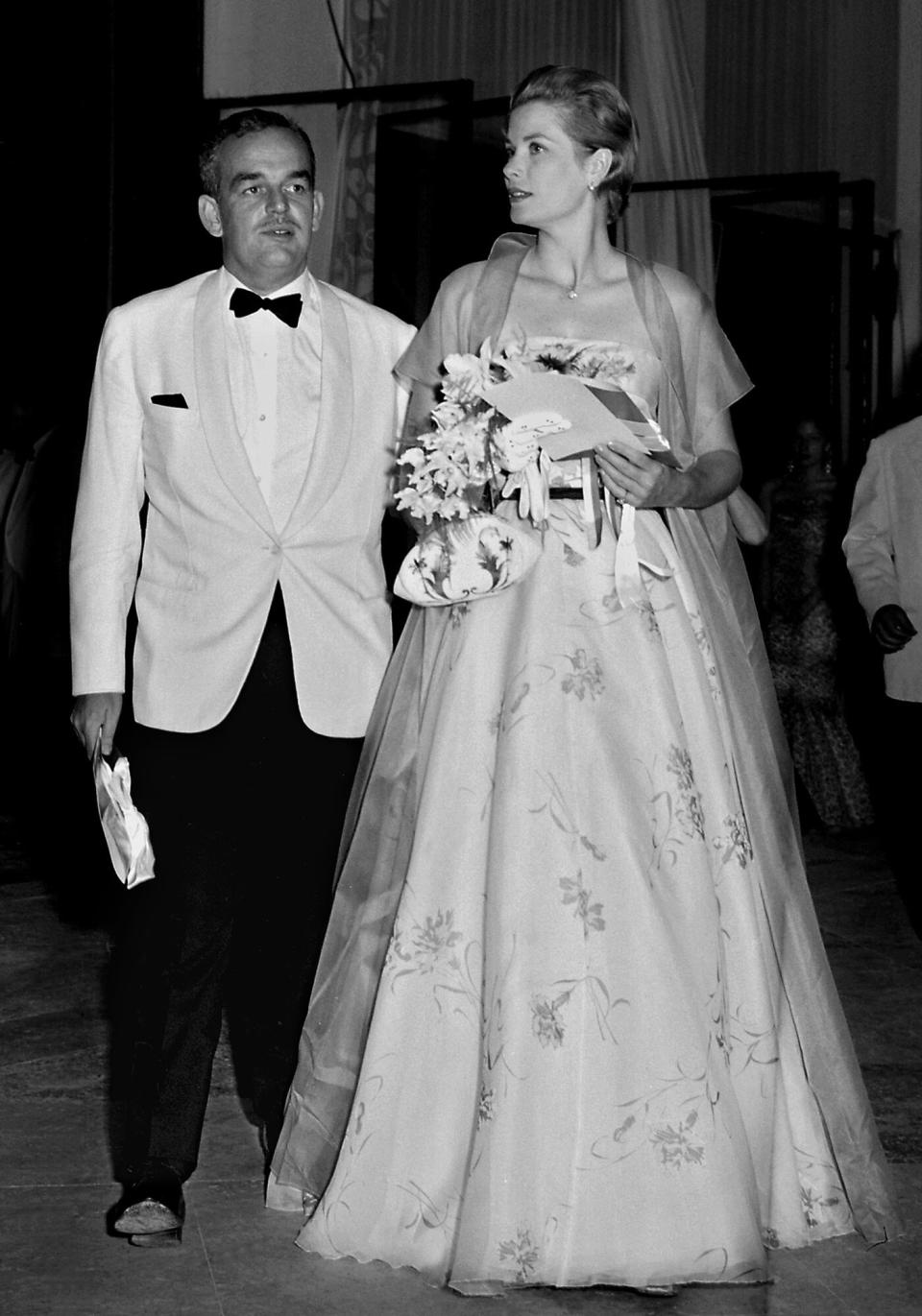 Princess Grace and her husband Prince Rainier of Monaco arrive 19 July 1958 at Monaco Sporting Club for the annual Red Cross gala ball.