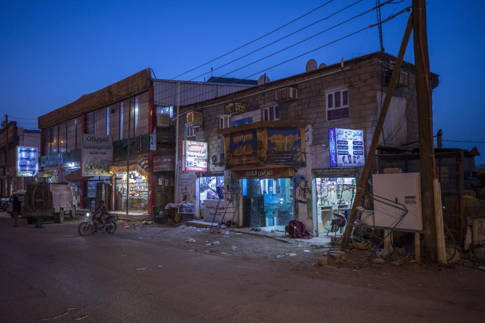 Shops are open for business in Marib, Yemen, Monday, June 21, 2021. On the most active front line in Yemen's long civil war, the months-long battle for the city of Marib has become a dragged-out grind with a steady stream of dead and wounded from both sides. (AP Photo/Nariman El-Mofty)