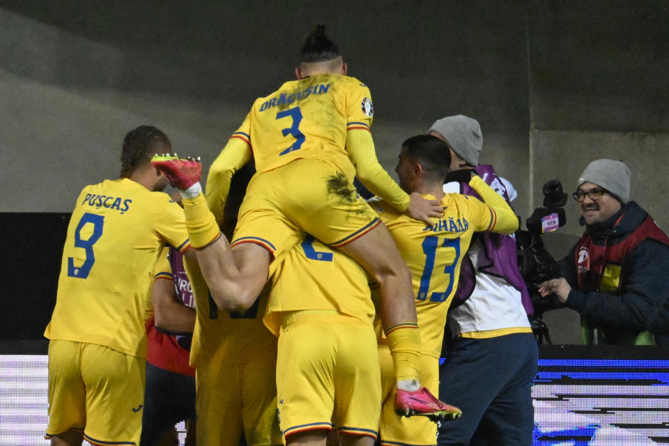 Romania's Ianis Hagi celebrates with teammates after scoring his side's second goal during the Euro 2024 group I qualifying soccer match between Israel and Romania at the Pancho Arena in Felcsut, Hungary, Saturday, Nov. 18, 2023. (AP Photo/Denes Erdos)