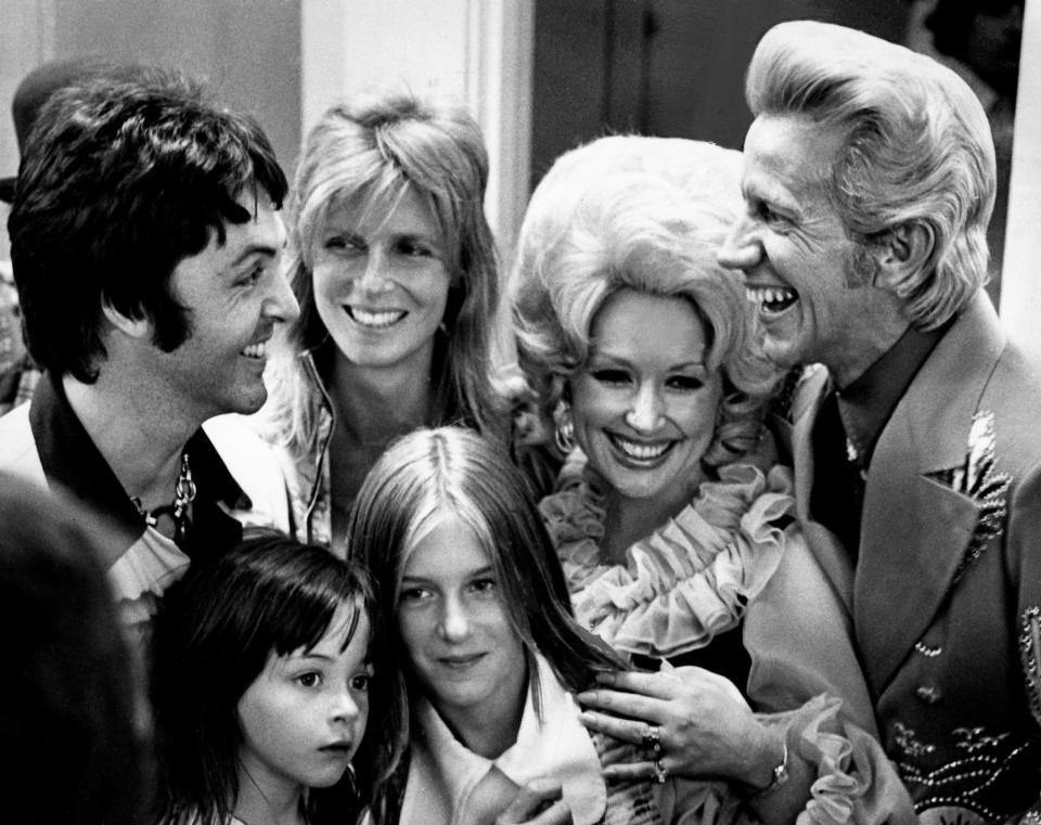 Former Beatle Paul McCartney, left, and his family chat with Dolly Parton, second from right, and Porter Wagoner backstage during the third annual Grand Masters Fiddling contest at Opryland on June 16, 1974. McCartney's wife, Linda, and daughters Heather, 11, and Stella, 4, also enjoyed the music at the event.