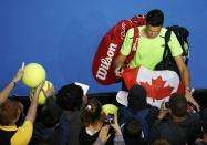 Milos Raonic of Canada signs autographs after defeating Feliciano Lopez of Spain to win their men's singles fourth round match at the Australian Open 2015 tennis tournament in Melbourne January 26, 2015. REUTERS/Thomas Peter