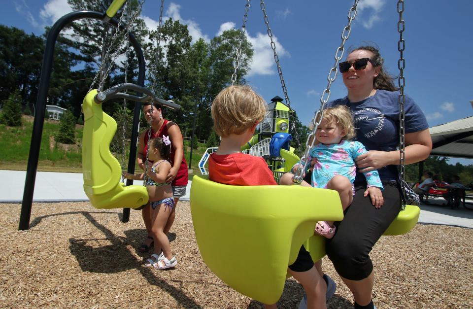Jaclyn Rhyne and her two children, Nolan and Maddie, enjoy the swings on the playground at Stinger Park on North 12th Street in Bessemer City Thursday afternoon, July 6, 2023.