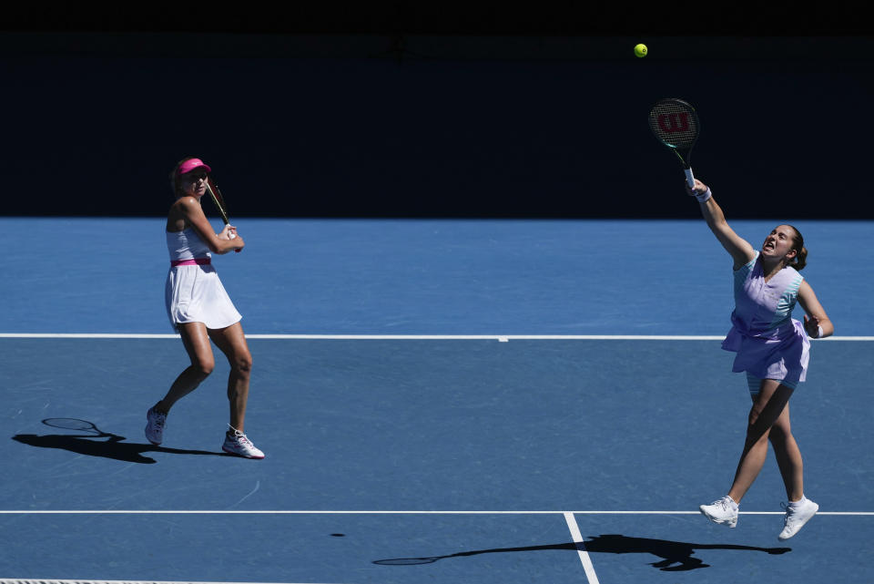 Jelena Ostapenko, right, of Latvia and Lyudmyla Kichenok of Ukraine in action against Hsieh Su-Wei of Taiwan and Elise Mertens of Belgium during the women's doubles final at the Australian Open tennis championships at Melbourne Park, in Melbourne, Australia, Sunday, Jan. 28, 2024. (AP Photo/Alessandra Tarantino)