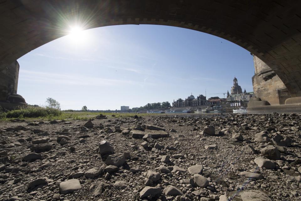 The banks of the river Elbe in Dresden, Germany, are seen running dry on a hot Tuesday, June 25, 2019. Germany expects the hottest day of the year so far. (Sebastian Kahnert/dpa via AP)