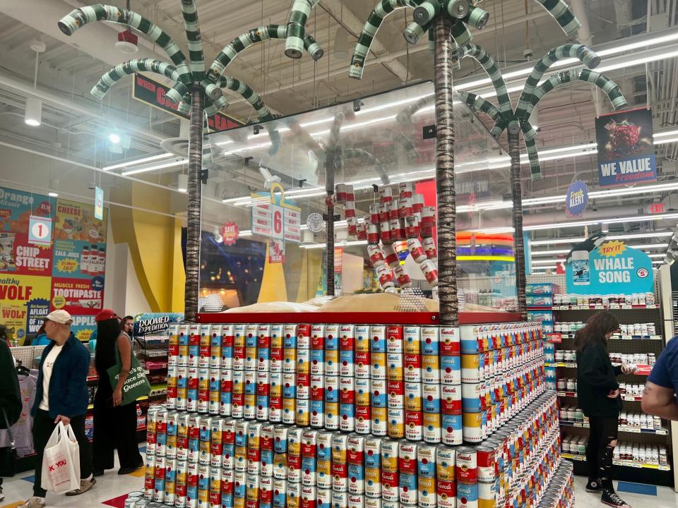 A tower of canned soup inside Omega Mart.