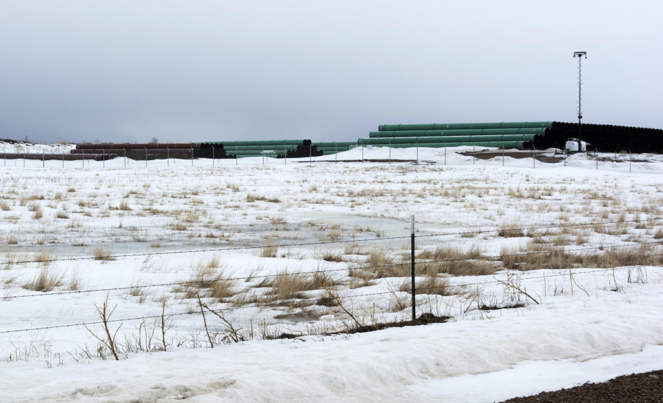 This March 11, 2020 photo provided by the Bureau of Land Management shows a storage yard north of Saco, Mont., for pipe that will be used in construction of the Keystone XL oil pipeline near the U.S.-Canada border. A Canadian company said Monday, April 6, 2020, that it's started construction on the long-stalled Keystone XL oil sands pipeline across the U.S.-Canada border, despite calls from tribal leaders and environmentalists to delay the $8 billion project amid the coronavirus pandemic. (Al Nash/Bureau of Land Management via AP)