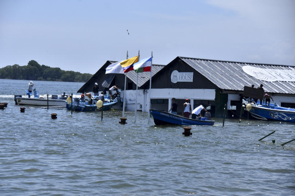 The Marine Museum of Puerto Bolivar, detached from the dock, is partially inundated in water after an earthquake that shook Machala, Ecuador, Saturday, March 18, 2023. The U.S. Geological Survey reported an earthquake with a magnitude of about 6.8 that was centered just off the Pacific Coast, about 50 miles (80 kilometers) south of Guayaquil. (AP Photo/Jorge Sanchez)