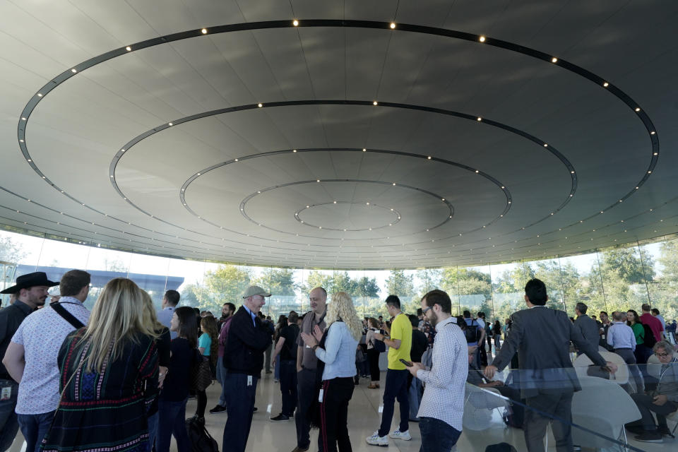 People arrive at Apple for an event to announce new products Tuesday, Sept. 10, 2019, in Cupertino, Calif. (AP Photo/Tony Avelar)