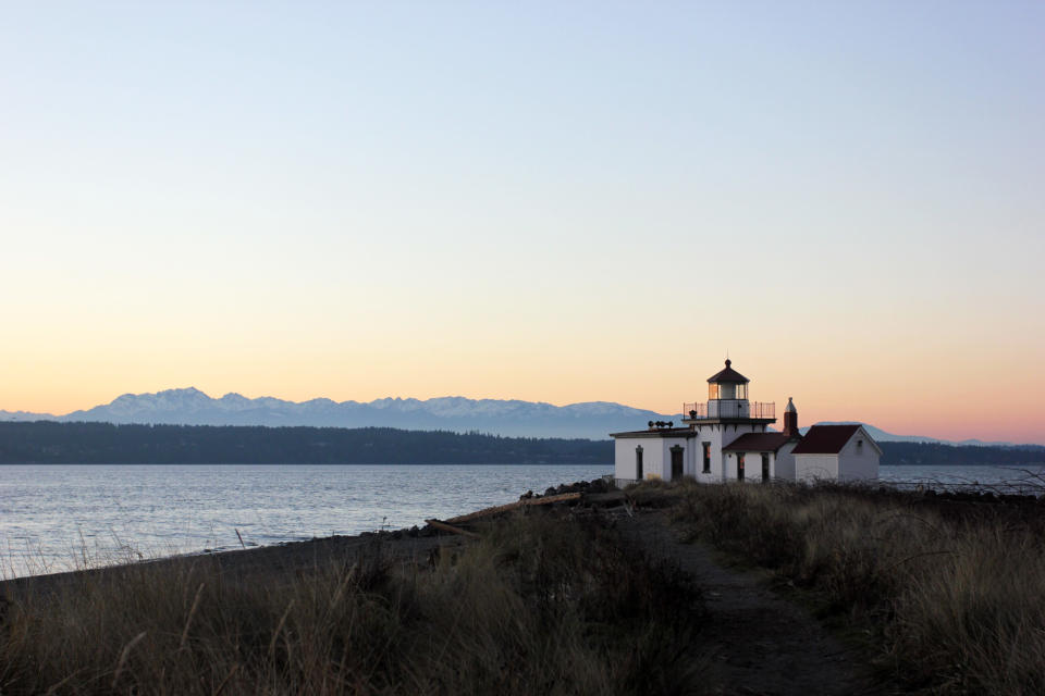 In this image taken Jan. 16, 2013, a lighthouse lines the beach at Discovery Park in Seattle. At 534 acres, Discovery Park is the largest park in the city and it features seaside bluffs, views of the Puget Sound, trails, a light house and a beach. (AP Photo/Manuel Valdes )