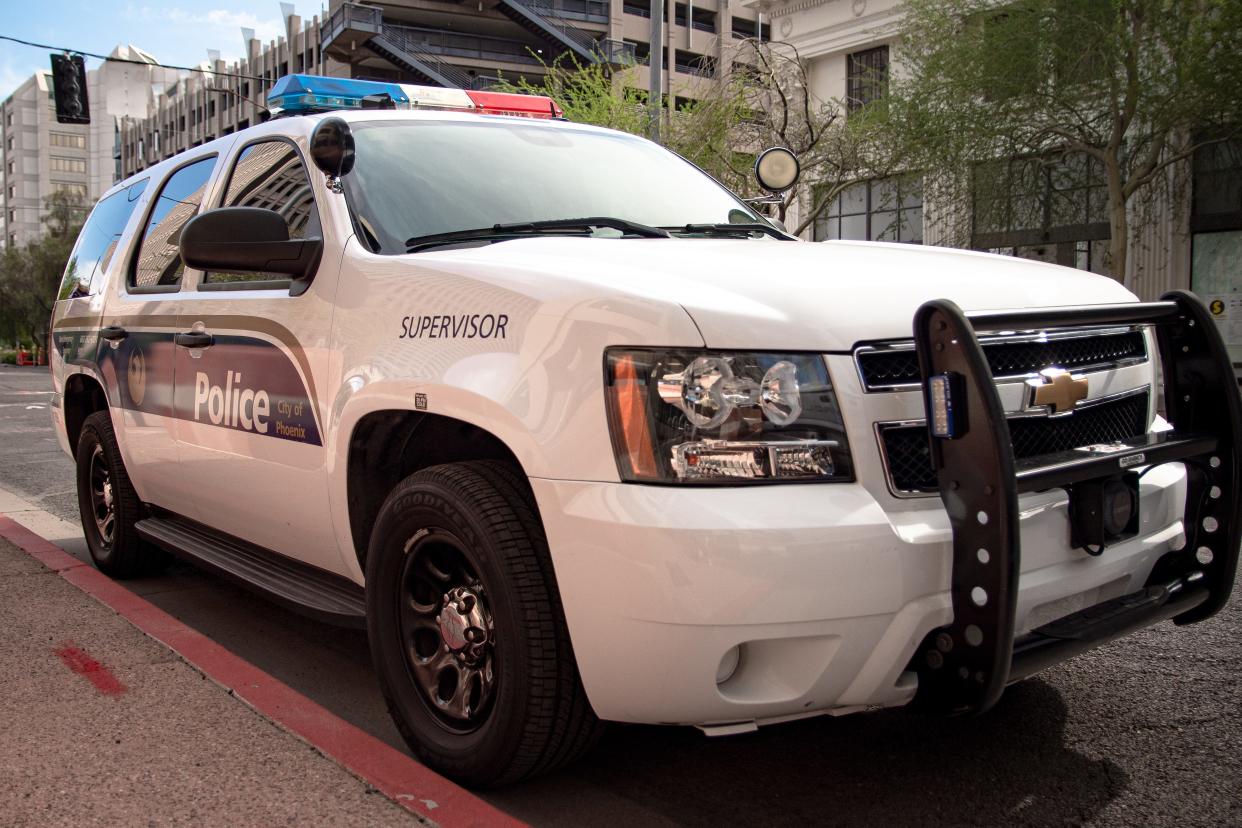 A Phoenix Police cruiser can be seen.