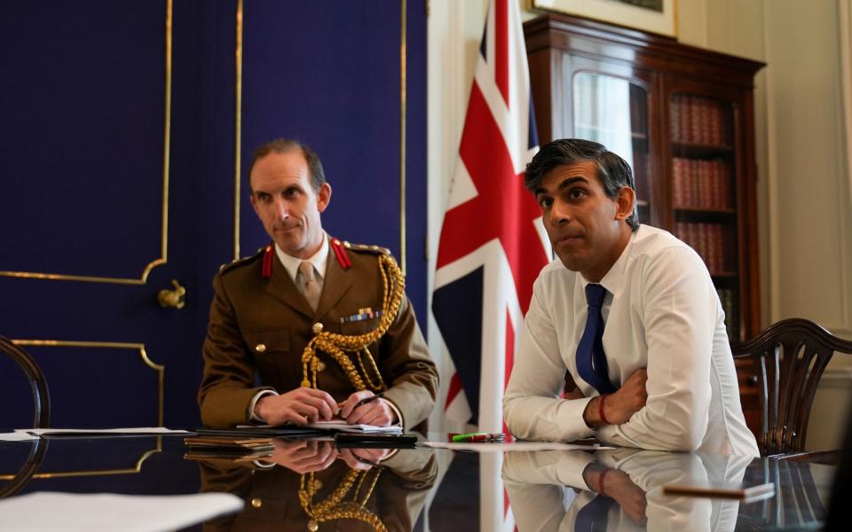 Prime Minister Rishi Sunak is briefed by staff before holding a call with leaders from the G7 nations in response to the Iran missile strikes on Israel