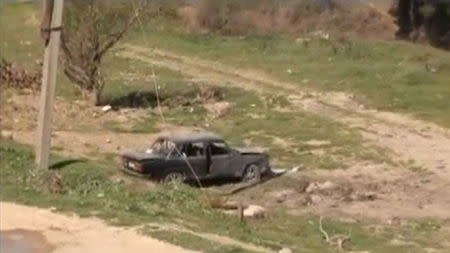 A car which was damaged during clashes between Armenian and Azeri forces is seen in Nagorno-Karabakh region, which is controlled by separatist Armenians, in this still image taken from video provided by the Nagorno-Karabakh region Defence Ministry April 2, 2016. REUTERS/Nagorno-Karabakh Military Handout via Reuters TV